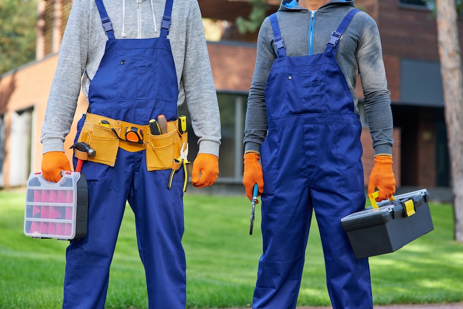 construction workers holding tools wearing blue ov 2026 01 09 07 07 10 utc