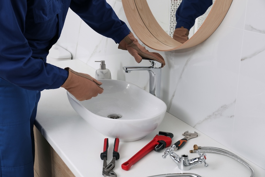 plumber repairing sink in a modern bathroom 2026 01 19 18 20 09 utc
